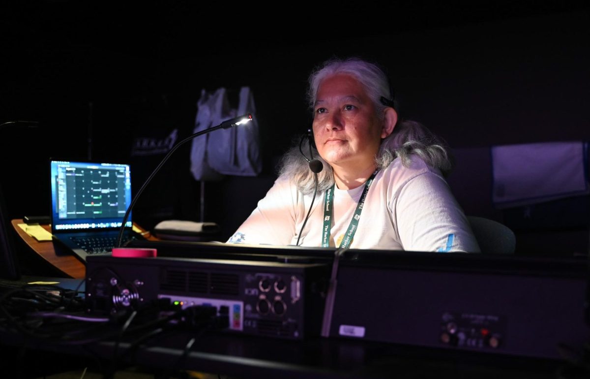 Theater technician specialist Natti Pierce-Thomson works the light board in the Patil Theater. Pierce-Thomson joined the Harker tech crew over 20 years ago, designing and operating the stage light systems.