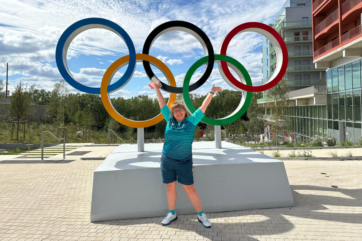 World Languages and Cultures Teacher Tamara Smith poses in front of the Olympic rings in the athletes village at the 2024 Paris Olympics. Prior to volunteering at the Paris Games, Smith assisted at the 2014 Winter Olympics in Sochi, Russia.