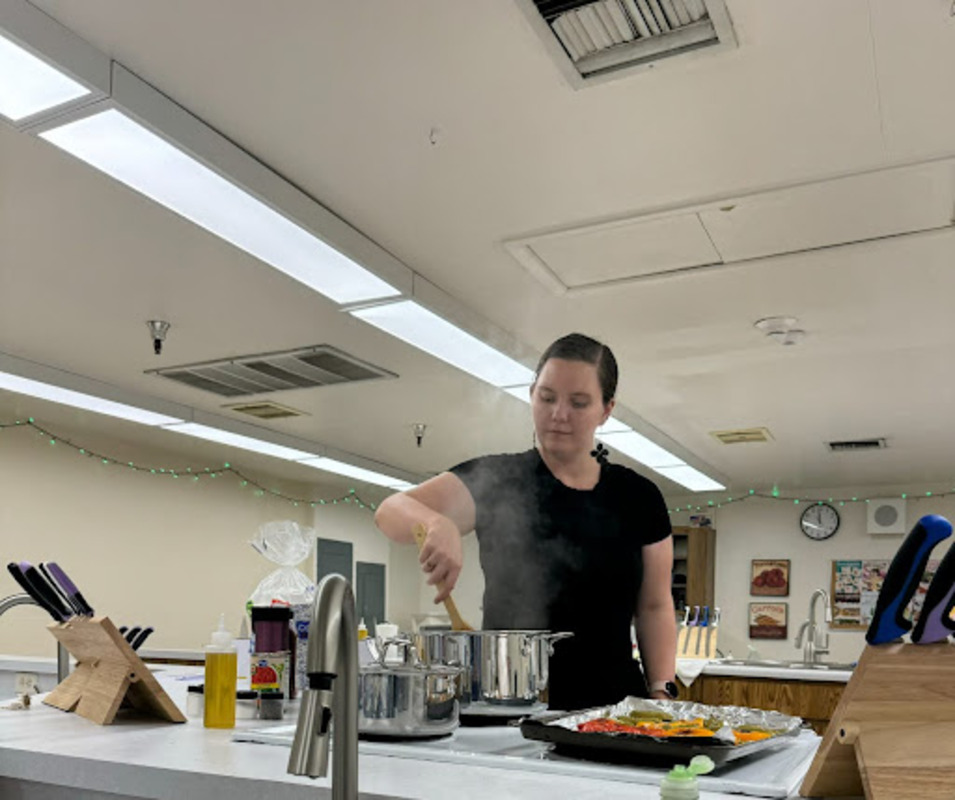 Rinaldi smiles as she stirs her ratatouille while preparing veggies off to the side. This dish was prepared in her fifth period Foods and Nutrition class.