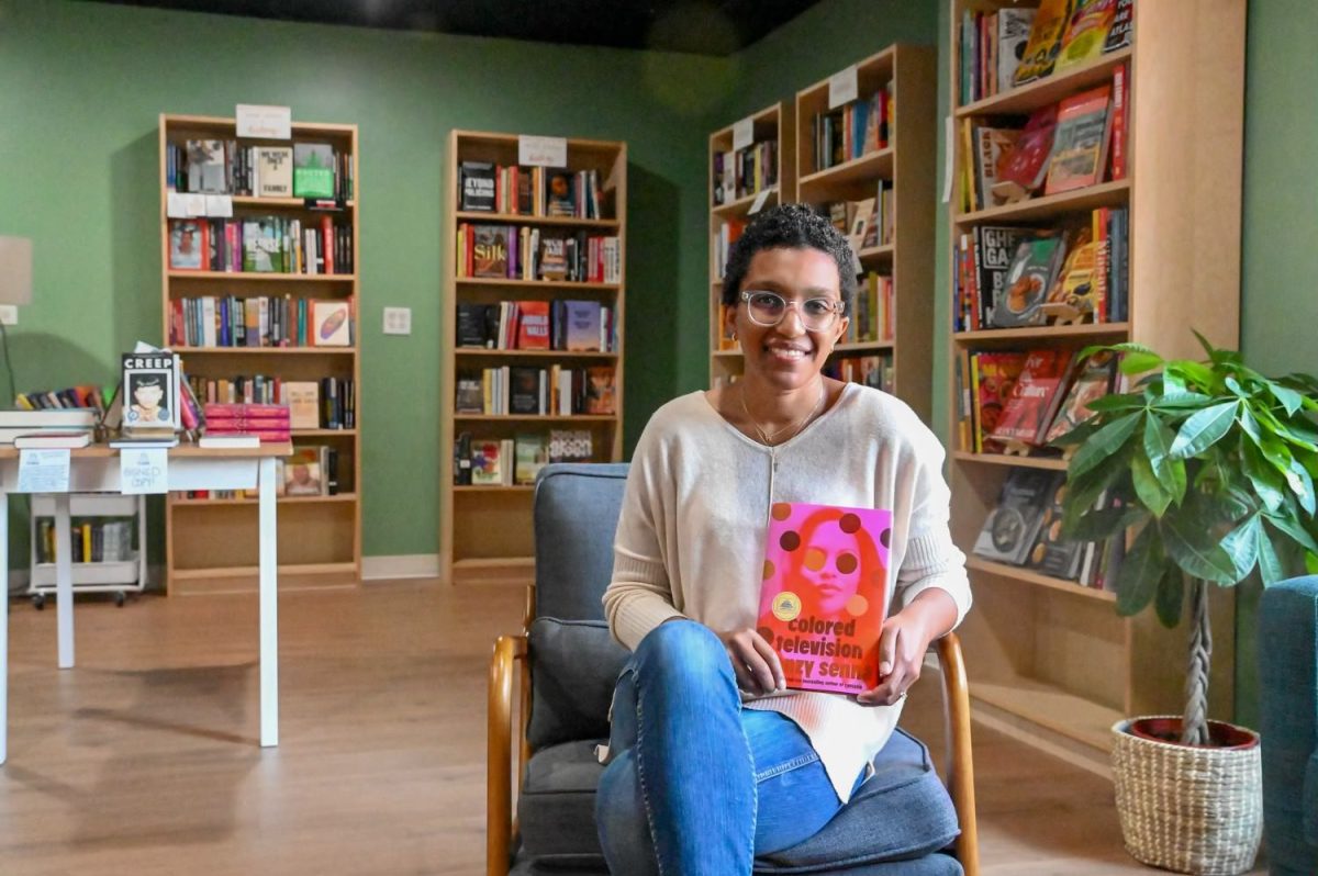 PROFOUND PERSPECTIVES. Courtney Bledsoe, owner of the newly opened bookstore Call and Response, poses with a book in her store. The bookstore opened on May 4, and it aims to share stories from authors of color.