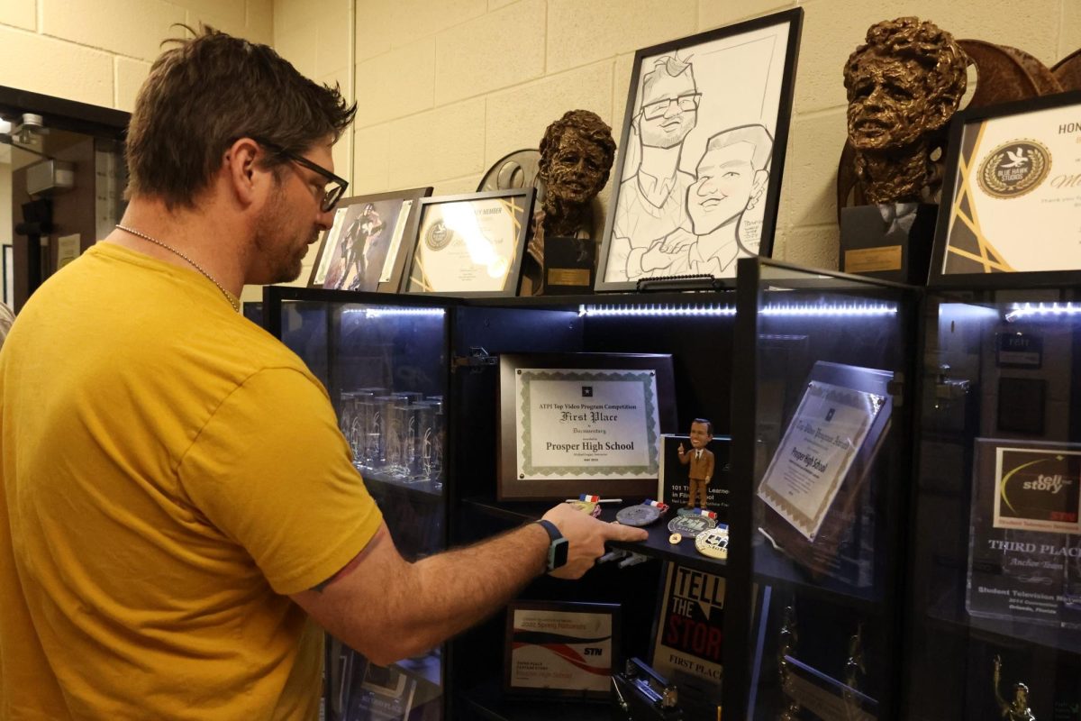 Trophy case open, film adviser Michael Logan showcases awards his team has achieved over the years. The film program won first at UIL state last year. On Oct. 15 the team will leave to go to New York City. They will be attending the All American High School Film Festival and compete throughout the week. 