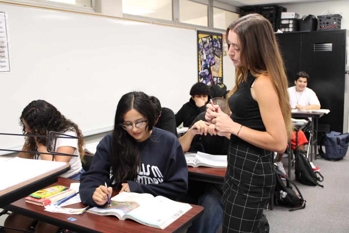 During fourth period, junior Melina Garcia (left) asks new English teacher Hannah Batchelor a question on Thursday, Sept. 5, in Room 33 about her Ralph Waldo Emerson’s “Nature” reading assignment in her textbook. Batchelor, who has been using Room 11 second period and Room 33 during zero, third and fourth periods since the start of the fall semester, is scheduled to move into her own classroom in Room 154 on Thursday, Oct. 17, or Friday, Oct. 18.