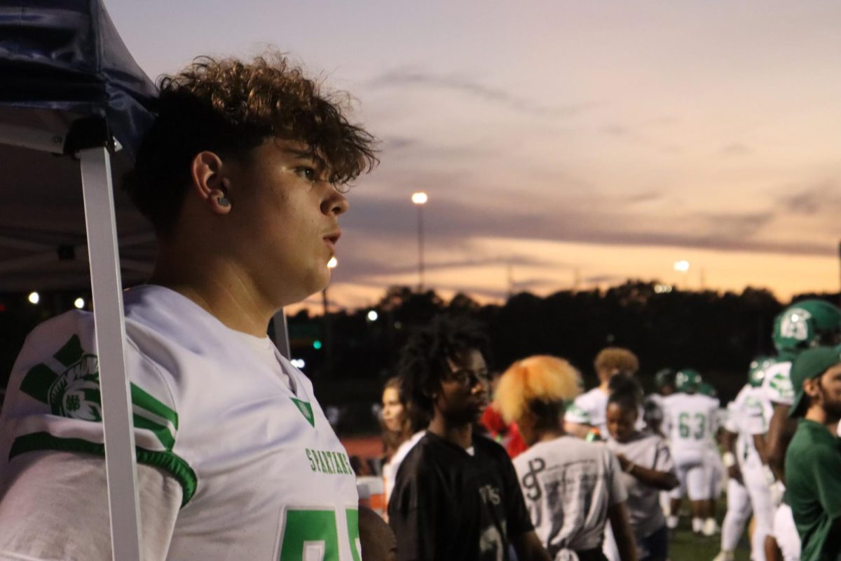 Brayden Washington (10) observes the football game while injured. Washington continued to be active with the team when injured.