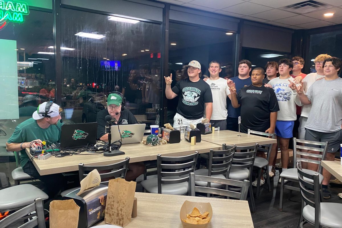 Holding up their T-Wolves, varsity football players smile for the camera at Taco Palenque. Last night, the O-Line position group was interviewed during Timberwolf Night in America, a weekly broadcast that features different aspects of the team and is hosted by Josh Willard and Brad Cone. “Timberwolf Night in America is an opportunity for us to learn about who the players are, because the team changes every year,” Willard said. “It's a chance to ask what they are looking to accomplish this week. We’ll go over the last game, preview this week's matchup, and talk about the record book. It's just fun talking about Timberwolf football.”