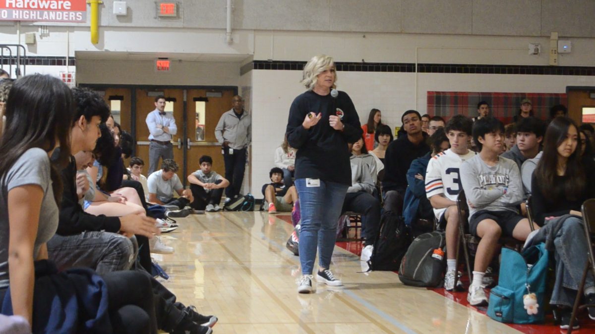 Love Like Adam founder Courtney White walks down the crowd of McLean juniors and seniors. The foundation spreads hazing awareness to schools and advocates for policies against hazing.