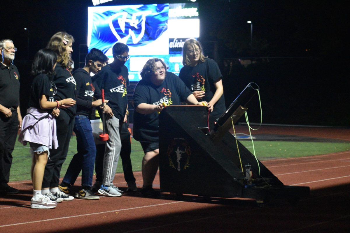 Error Code Xero, the Wilsonville High School robotics team, debuts their T-shirt launcher at the Homecoming football game on October 10. A hobby project developed by junior and robotics team member Cayden Whisman, the T-shirt launcher was designed to uplift the student body's engagement in school sporting events, and also bring awareness to the robotics team's commitment to STEM creation.