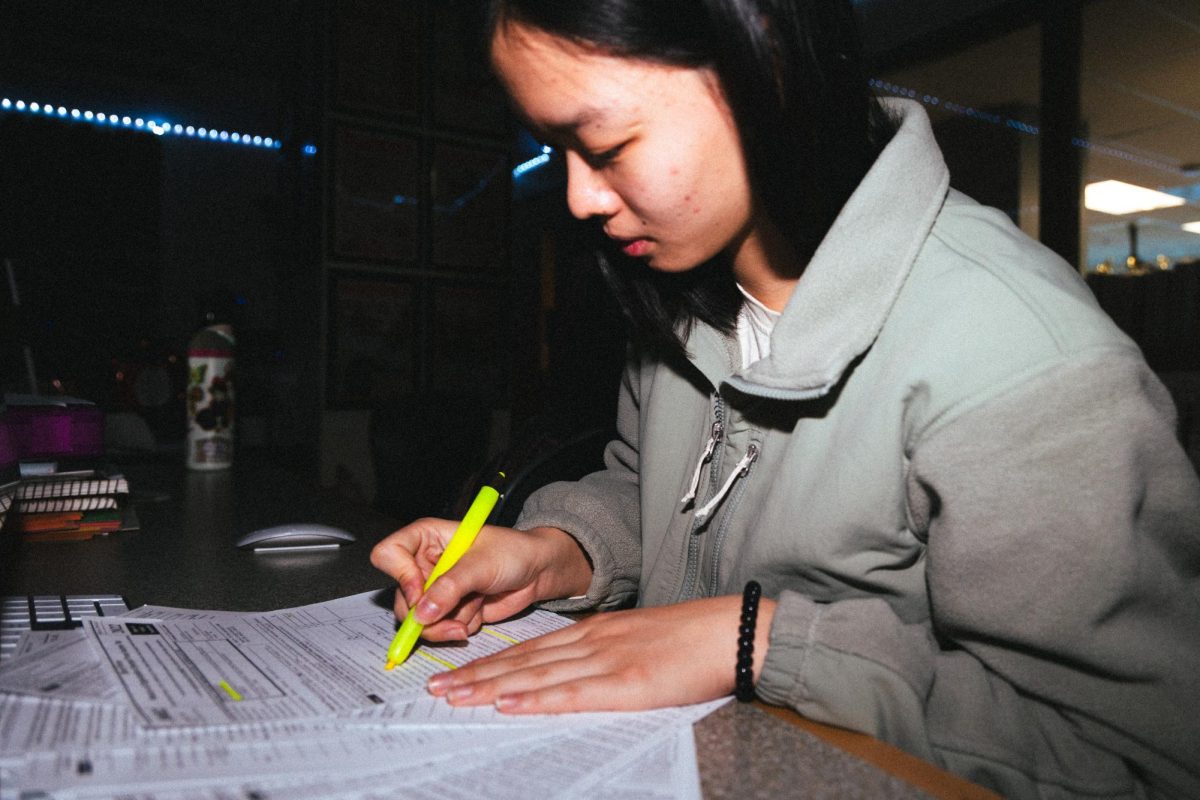 Senior Helen Liang analyzes the tax forms for Youth Voices, a local student-led nonprofit. Liang helped lead free debate coaching with the organization's leadership development team until the program was discontinued in December 2023.