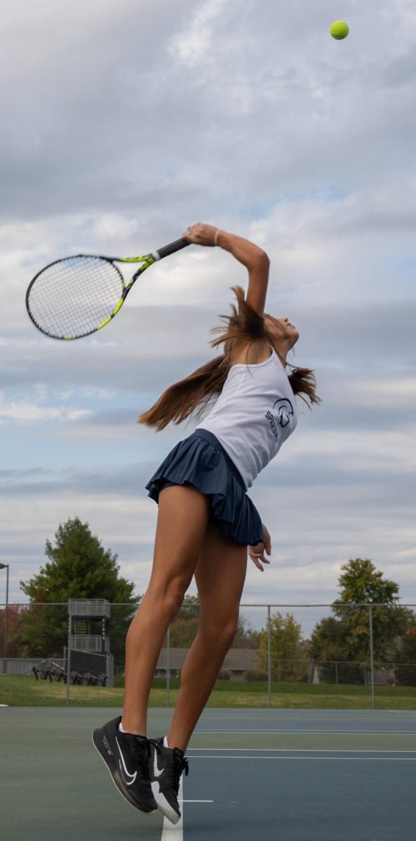 Freshman Ashley Hayes jumps to serve the ball. Hayes' powerful serve was part of what set her apart from her opponents.