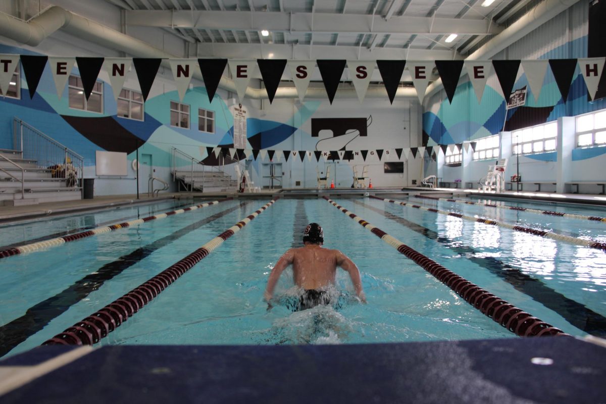 Simon Hutchinson warms up before practice by swimming laps in the pool.  