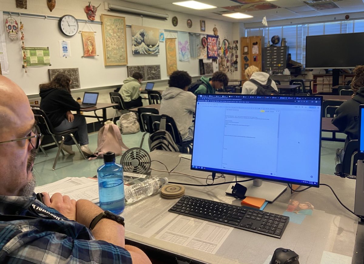 Social studies teacher Mitchell Joy analyzes an AP World student's work using the timeline feature in the Brisk program. Brisk allows educators to see students type each word, making it much easier for teachers to ensure that students do not use AI or other students' work to cheat. 