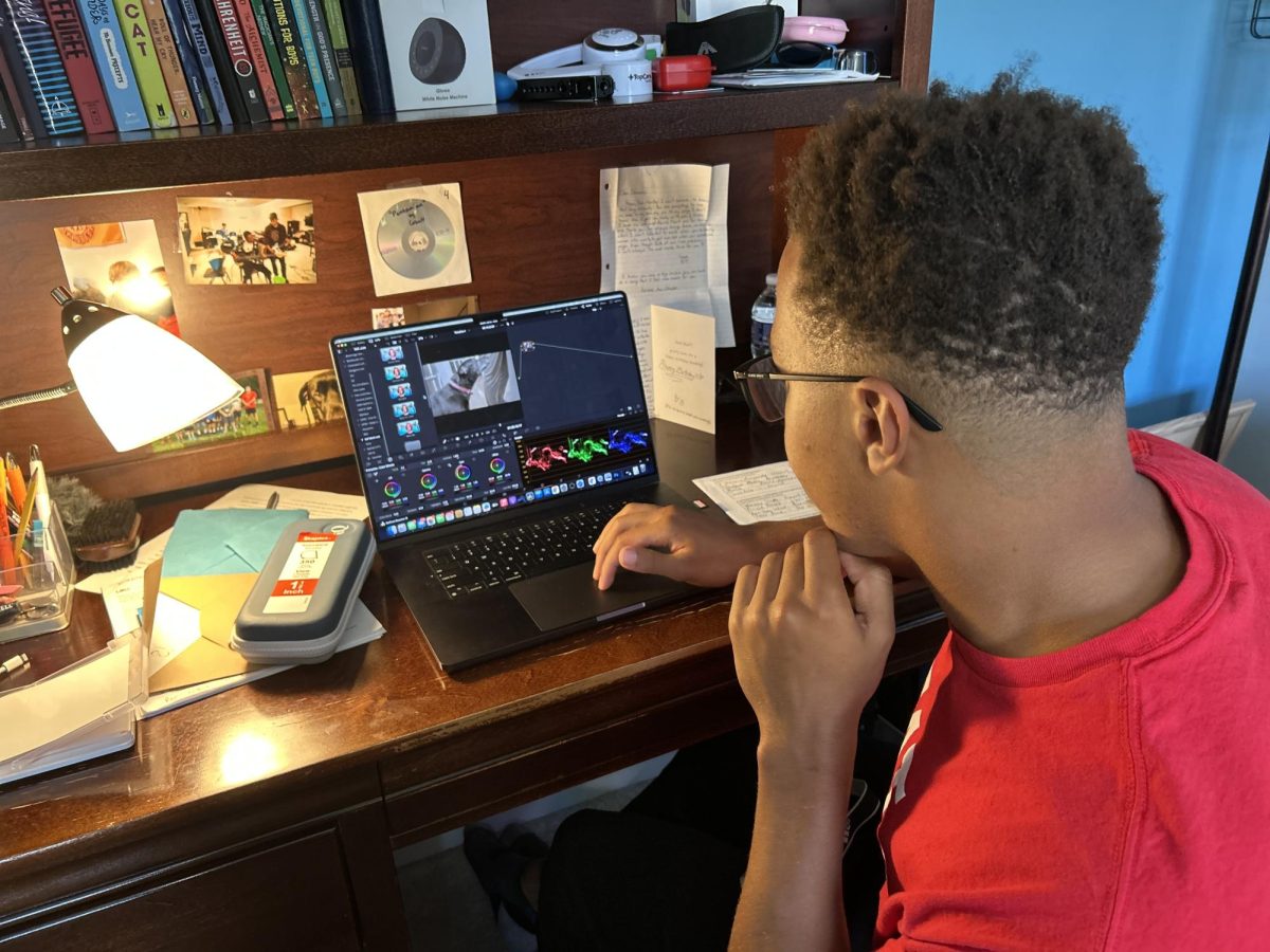 Farrow sits at his desk and edits on his computer.