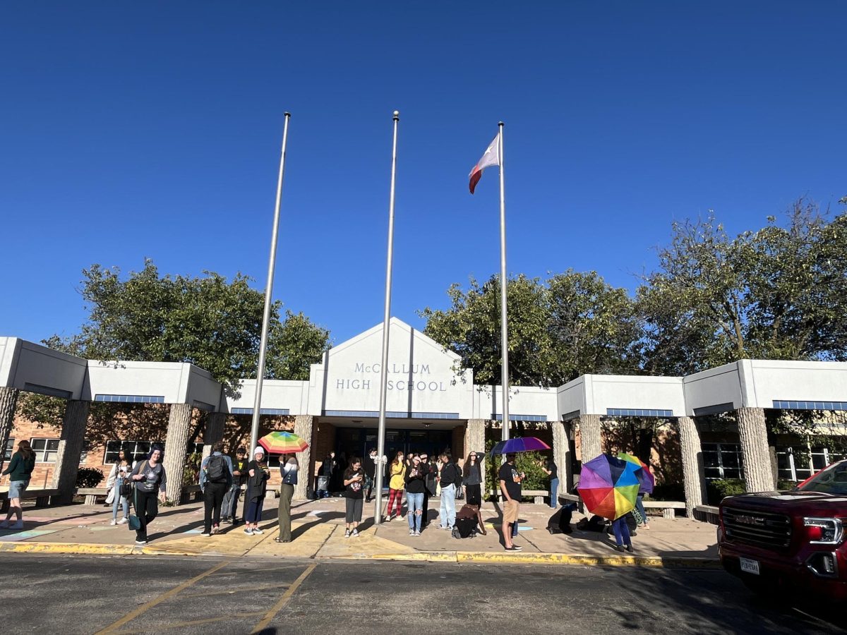 While parents and teachers formed a marching line with rainbow umbrellas to insulate students from the hateful messaging coming from the sidewalk, students wrote supportive messages with sidewalk chalk to express support for the same groups that the agitators were villifying.