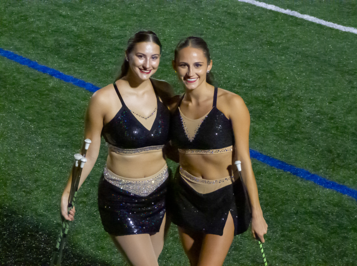 Stevenson University feature twirlers Katelyn Sypolt (left) and Gianna Romero (right) minutes before their halftime performance during Stevenson football’s Opening Night.