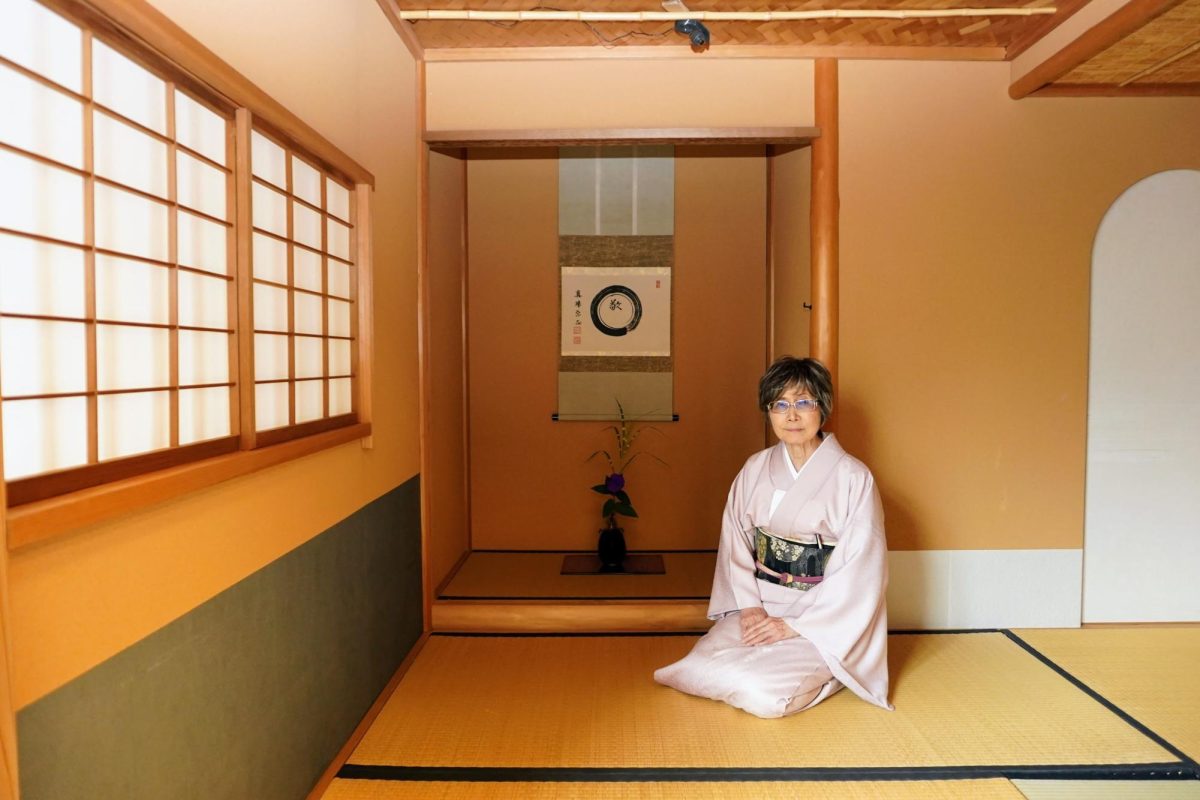 Professor Midori McKeon poses for a photo in the Toshiko Mishima Memorial Tea Room on Sept. 13, 2024. She is wearing a kimono with a flower pattern and an obi with a design inspired by the four seasons. (Neal Wong / Golden Gate Xpress)