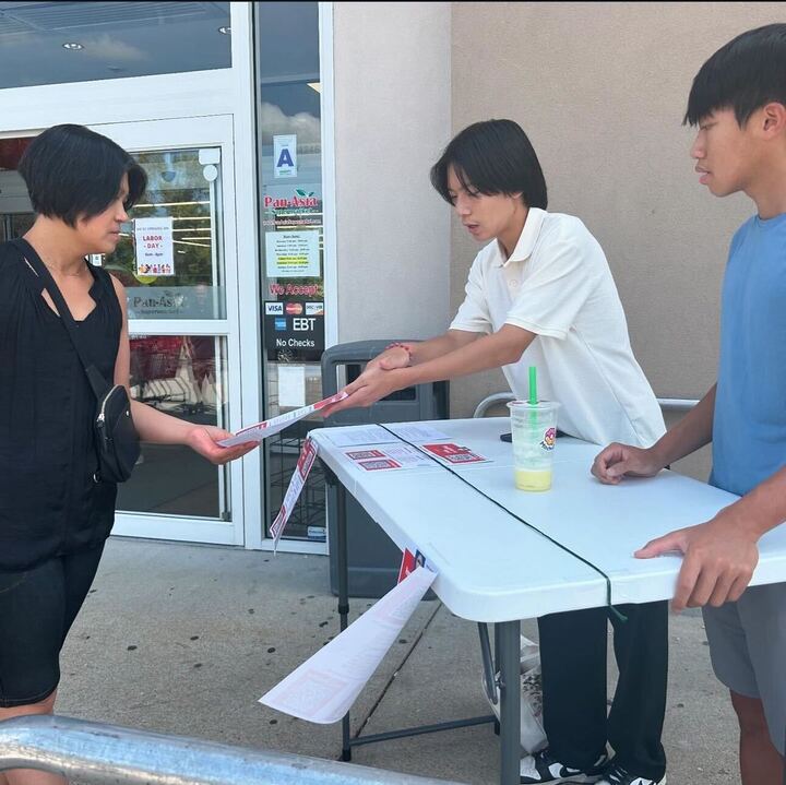 Juniors Eric Chen (left) and Brendan Yn (right) distribute fliers about voting outside of PanAsia. The juniors are participate in the Civic Fellowship Program, one of the Asian American Civic Scholars organization’s initiatives. 