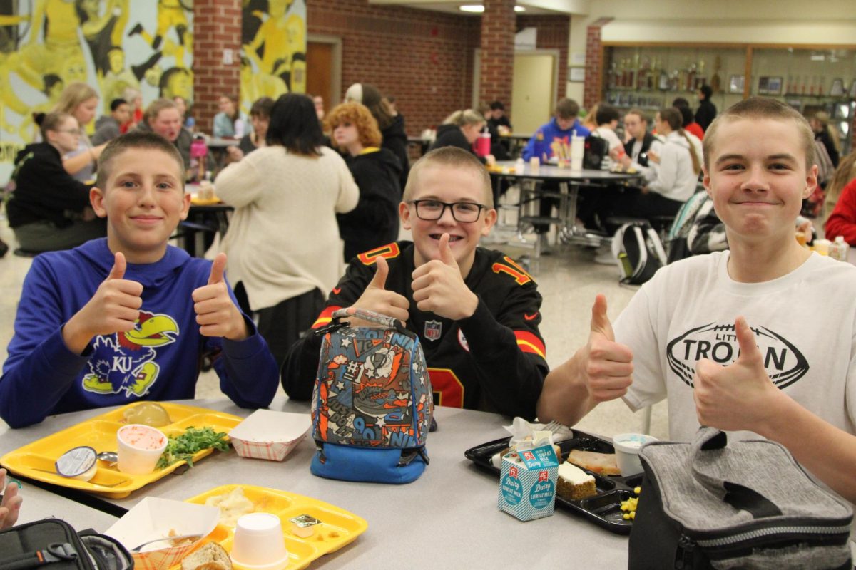 Brandon Wagner, Colin Harris, and Draven Mitchell enjoy their lunches as they are asked about their new dos. 