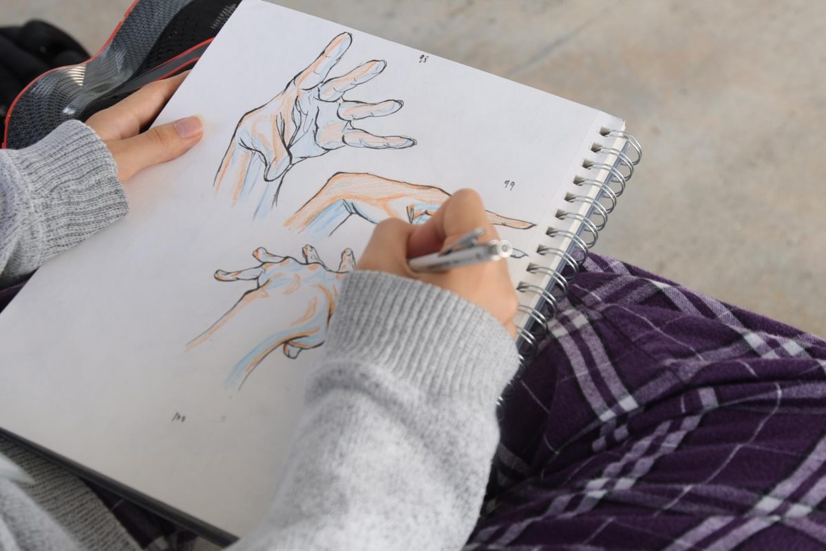 Visual senior Claire Natanek sits on the astroturf outside Building 9 during lunch to draw keyframes for her latest project. In animation, a keyframe is a drawing showing the beginning or end point of an action. These keyframes allow the motion to flow smoothly in the final product. 