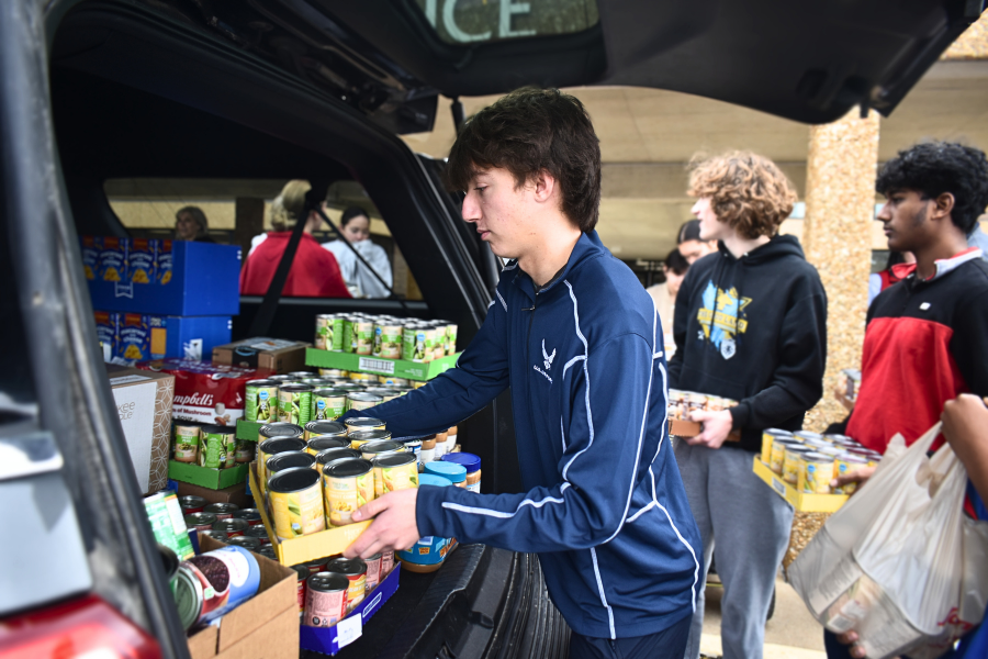 Adding a tray of canned corn to the pile, junior Michael Collop assists in transporting donations for the Holiday Food Drive. The event, hosted schoolwide from Dec. 10-17, raised over 5,000 food items to deliver to the Parkway Food Pantry, helping several families in need. [The drive] is a great thing for us to do because you're giving to those who are less fortunate, and it helps provide for people who can't provide for themselves. [The] competition is always fun, too. It was fun to be in [social studies teacher Jess] Chazen’s class, because he always gets worked up over [the competition]. He made it exciting, and was always convincing us to turn in cans for the drive,” Collop said.