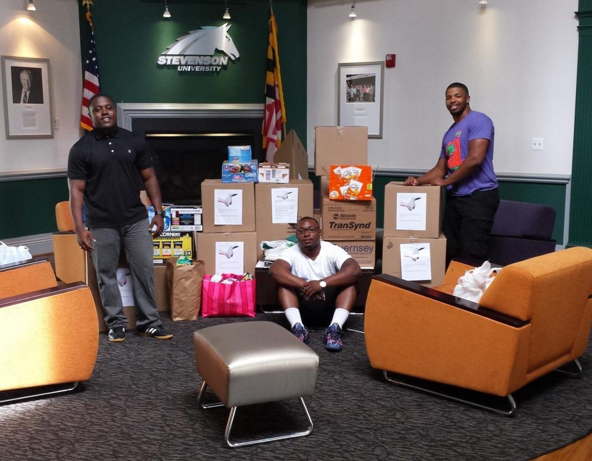 Alphonso Mayo, Donnuelle Durham and David Parker (left to right) delivered boxes full of canned goods to Sarah's Hope while they were students at Stevenson.