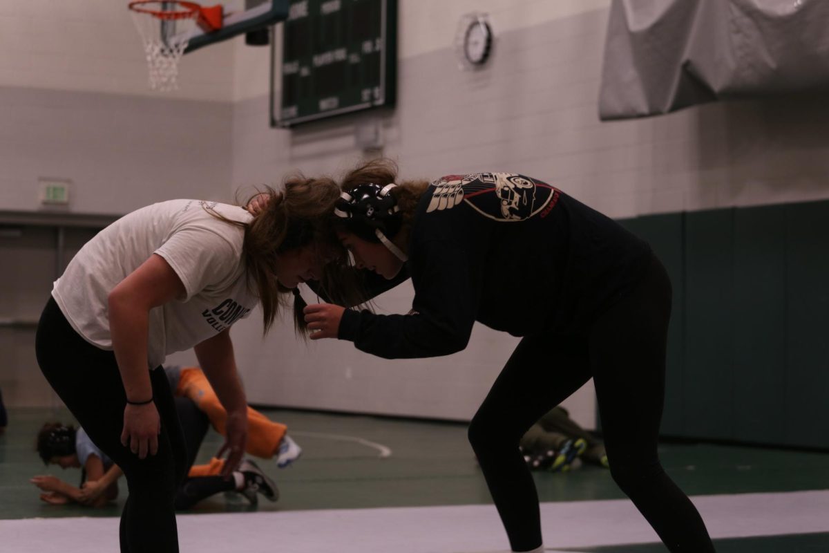 Sophomore Penny Dickinson faces off against her opponent in neutral position in a practice match.  "I really want to be confident, confident in my skills, and really be able to do what I’m capable of doing,” Dickinson said. 