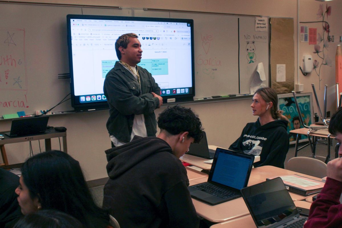 Garcia checks in with a student during his second period IB Language and Literature 11 class. The class worked on practice essays in preparation for the Higher Level essay required by IB Langauge and Literature 12.