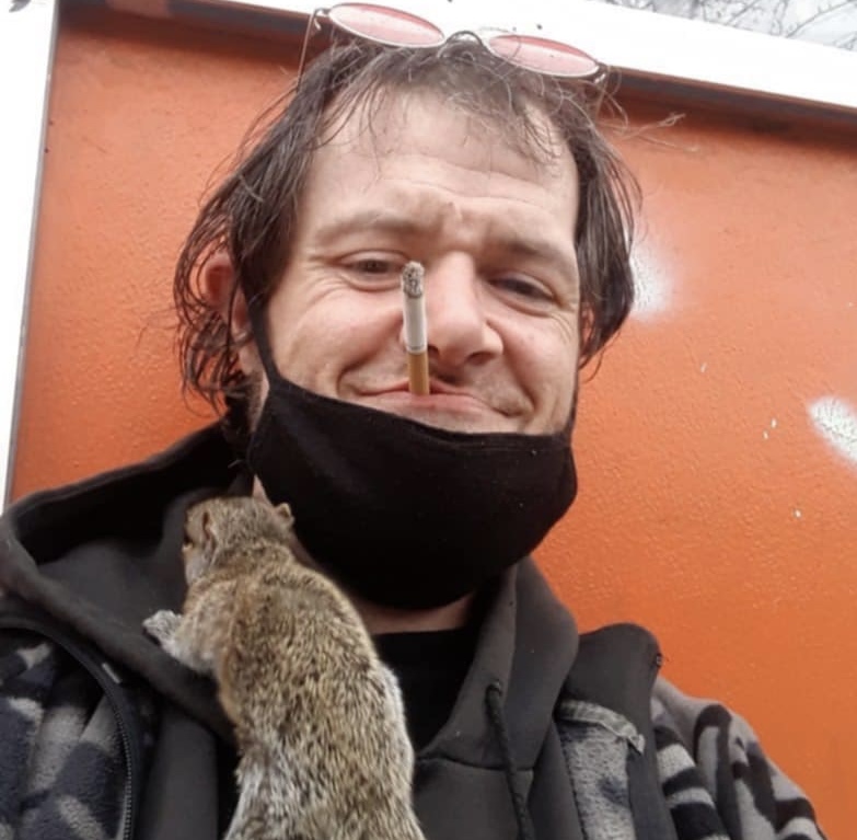 Jacob "Beetlejuice" Williams hanging out around Royal Cigar and Tobacco with a squirrel. Courtesy of Jacob Williams.