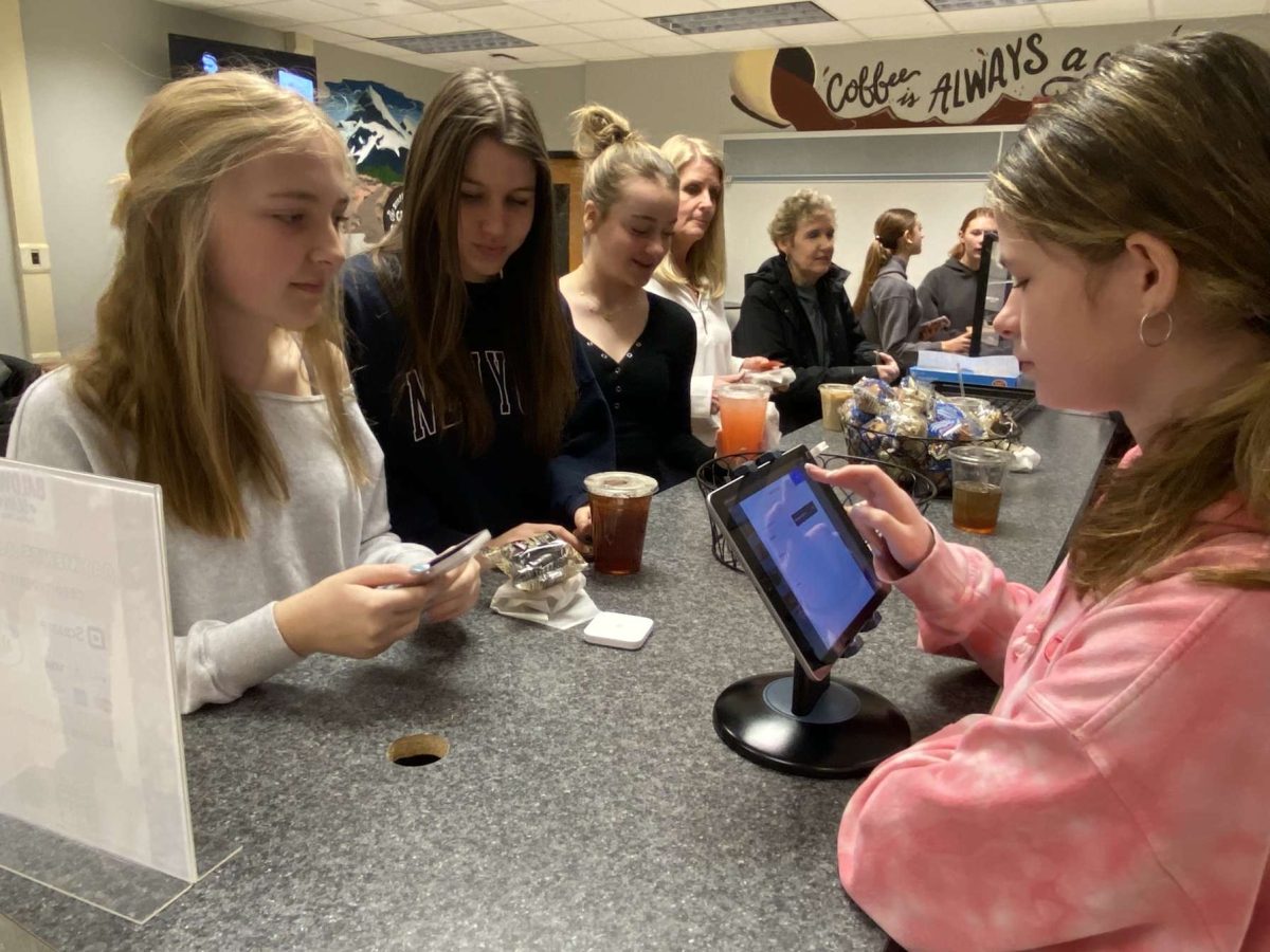 Freshman Gracey Zankel-Burge rings up customers at the Baldwin Bean. 