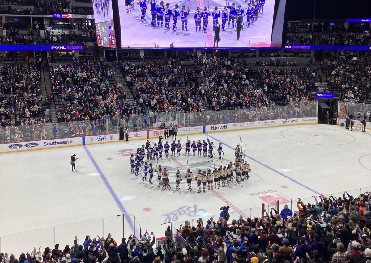  All players from both the Minnesota Frost and Montreal Victoire gather in the middle of Ball Arena to a standing ovation after their matchup on Jan. 12. “It gets me excited to be able to watch people like me have the ability to play the sport I love watching professionally,” junior Bel Perez, who was in attendance, said.