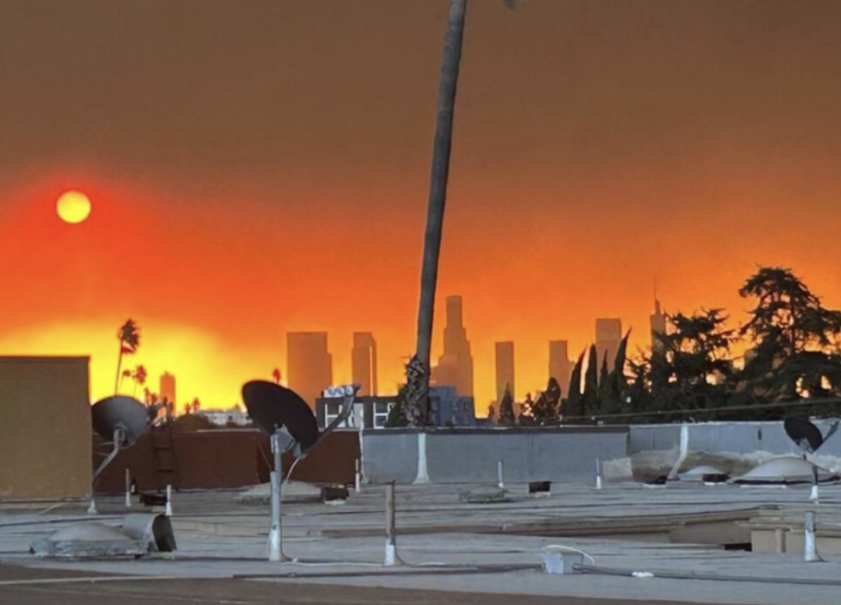 Light scattering on particles in the air from the fires gives the sky a scarlet orange appearance. Photo used with permission from Ashritha Nayini. 