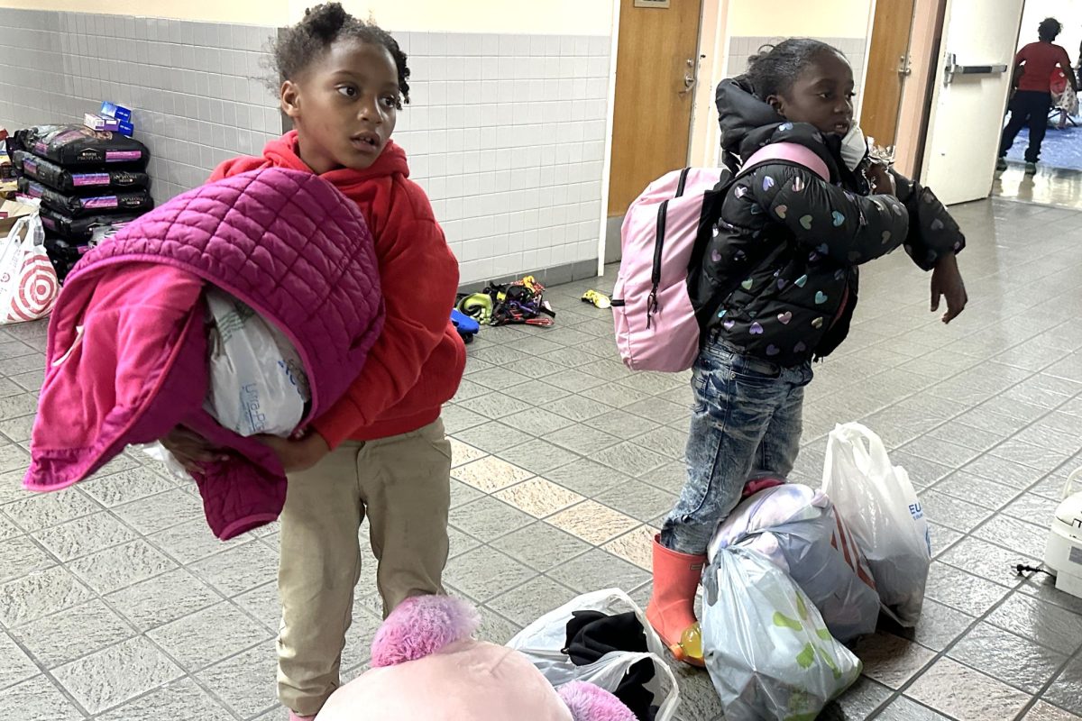 Two girls carry bags filled with clothes and supplies they gathered from the Westwood Recreation Center, one of the many facilities serving as an evacuation shelter during the fires. Marco Huitron, a volunteer at the center, said that he is willing to help and give back to the community. “The integrity, the love and the honor that we have here on the Westside — West Los Angeles, Santa Monica, Palisades, Venice, just literally on the coast side — it just has given us such a good family and community feel that it’s only within my want [to help],” Huitron said. “Help is everything that we need, especially in these times.”