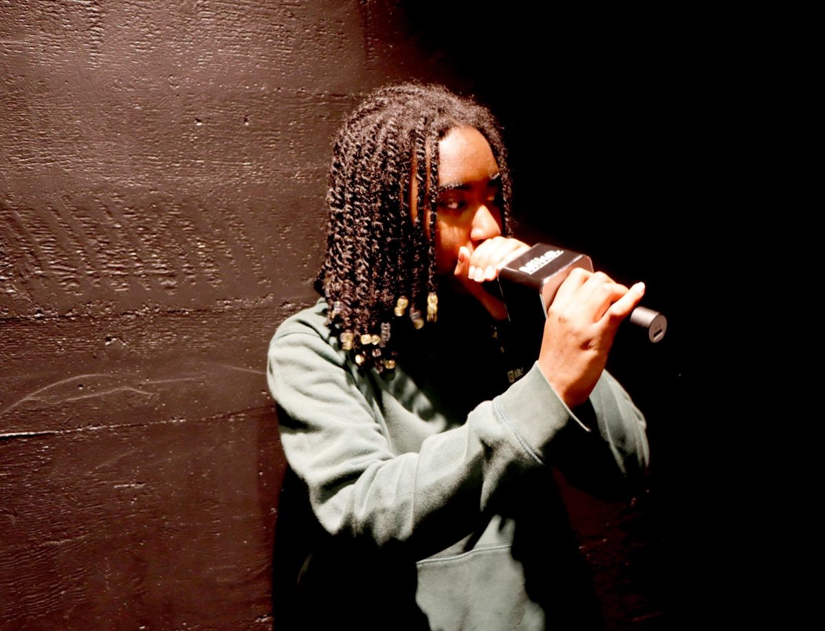 Elyse Harris (‘29) stands with a microphone pressed to her mouth, in the Blackbox, beatboxing. Harris has loved music and beatboxing since she was little and hopes to continue doing it throughout her life. “I feel like music is one of my strong suits,” Harris said. “It's one of my biggest passions.”