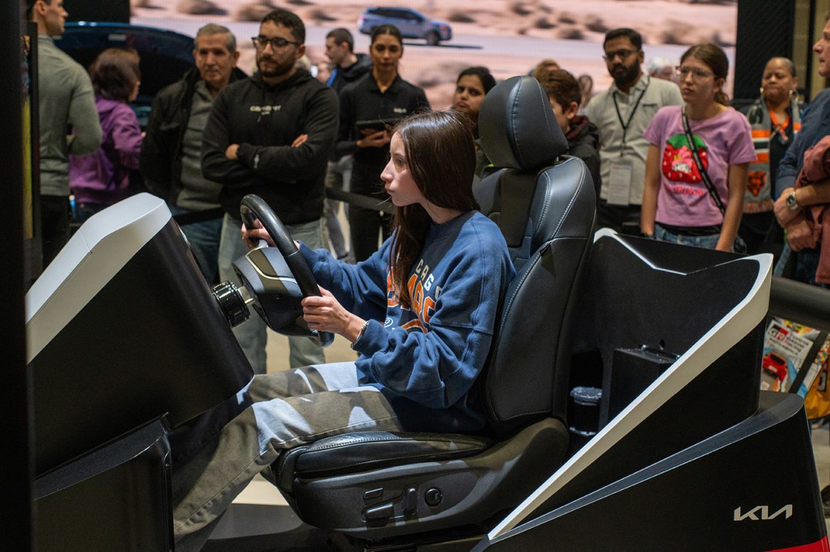 An attendee drives a Kia car simulation at the 2025 Chicago Auto Show, Feb.8-17. The auto show included other interactive elements for visitors, such as electric test tracks and ride-alongs.