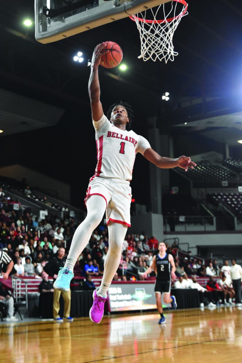 Shelton Henderson catches a basketball midair during a varsity game against Clear Springs High School last year. Henderson has played on varsity since he was a freshman.