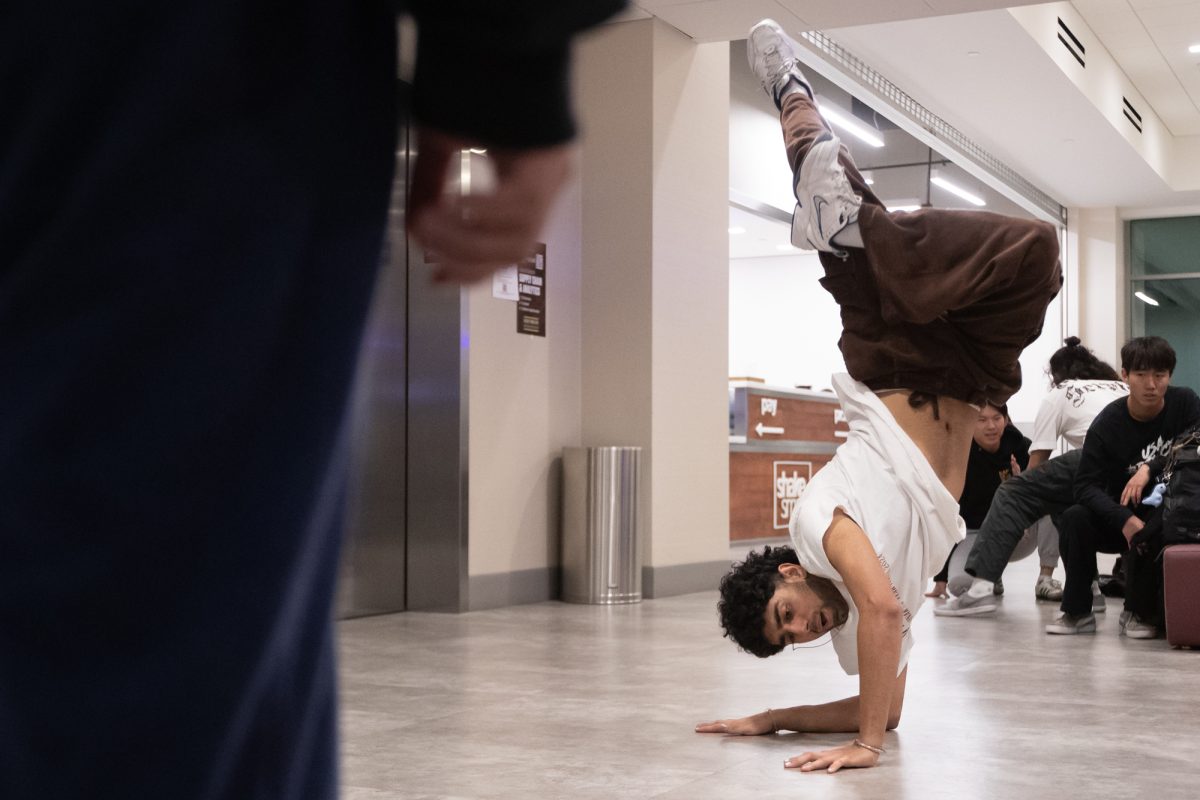 Electrical engineering junior Punish Kapoor, secretary of Freestyle Underground Street Dancers, breakdances in front of a member during a weekly Freestyle Underground Street Dancers ‘Freestyle Friday’ meet at the Polo Road Rec Center lobby on Friday, Jan. 24, 2025. (Chris Swann/The Battalion)