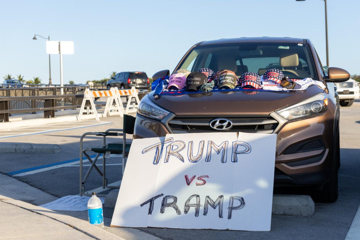 Leaning on Bob Kunst’s car, a sign saying, “Trump vs. Tramp” faces potential customers. Kunst is a local conservative activist in support of the Republican Party. The phrase on the sign references 2024 Democratic presidential nominee Kamala Harris as a “tramp,” a derogatory term for women suggesting promiscuous behavior.