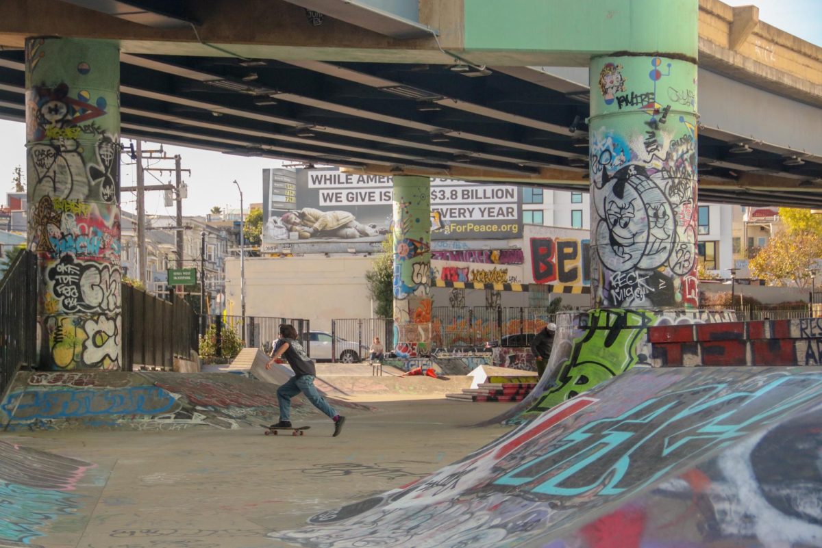 Underneath a freeway overpass in San Francisco, skateboarders glide across ramps adorned with graffiti at the South of Market (SoMa) West Skatepark. Despite providing a vibrant pop of color, graffiti can be visually disorienting to skaters and can even alter the textures of ramps, depending on the type of paint used. 