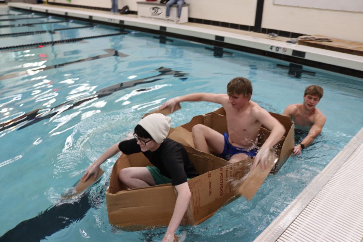 Teammates Junior Calvin Beyers & Senior Jack Hanks took the victory in this year's AP Physics Boat Regatta, alongside teammates Charles Brown II & Sebastian Liles, who helped design and direct the boat. Members of the AP Physics class worked together to create a cardboard boat with tape adhesive to see whose could last the longest in the Normal West pool on Thursday, Jan. 16.