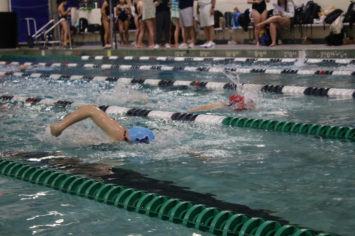 Paige Blom, sophomore, races at a girls swim meet on Thursday, Jan. 30. Blom broke the MHS girls 100-yard butterfly record on Saturday, Jan. 11 with a time of 56.79 seconds, 0.26     seconds faster than the previous record.