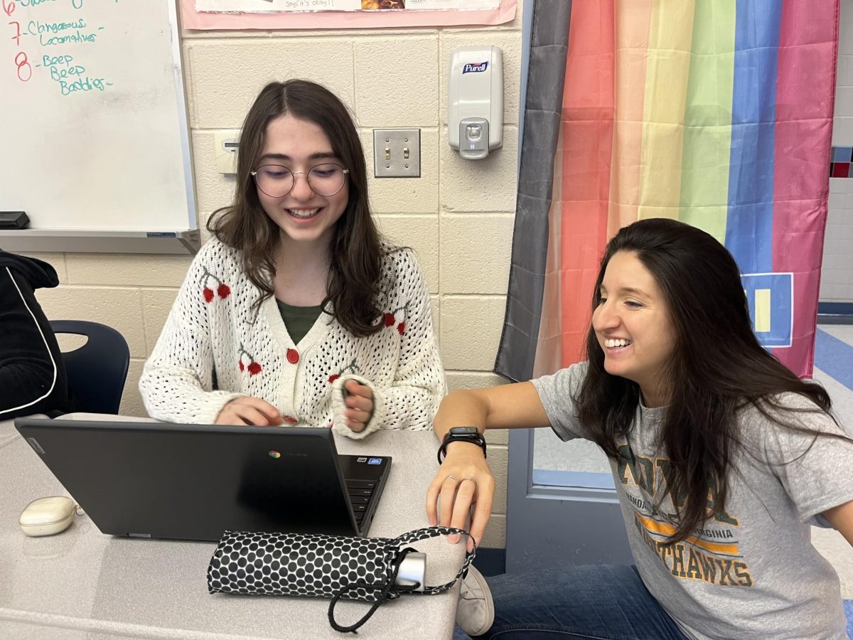 English teacher Katherine Bentley, right, helps out junior Simge Gerdaneri on an essay. Bentley said she is pleased with the phone ban.