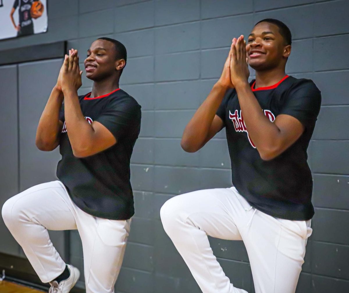 Juniors Akeem Cooper (Left) and Quantavius Bradley (Right) perform a cheer during the basketball game against Maynard Jackson on Jan. 28, where the girls won 59-50 and the boys lost 64-42. Cooper has been on the team for the past two seasons, and this is Bradley's first season.