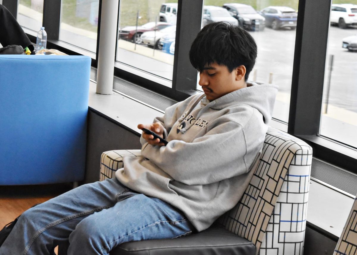 A familiar scene: phones take center stage in the library, leaving books untouched. Are we witnessing the decline of reading and writing habits among students?