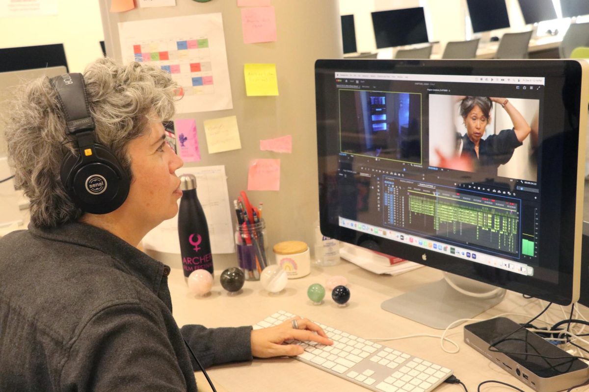 Brooke Sebold edits a film in their classroom. Their award-winning film, "I changed my mind" won a silver Anthem award. 