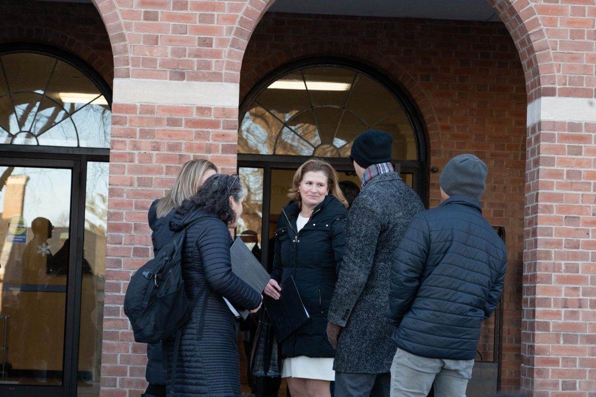 College President Nicole Hurd stands outside Marquis Hall with other administrators before entering the Tuesday faculty meeting.  