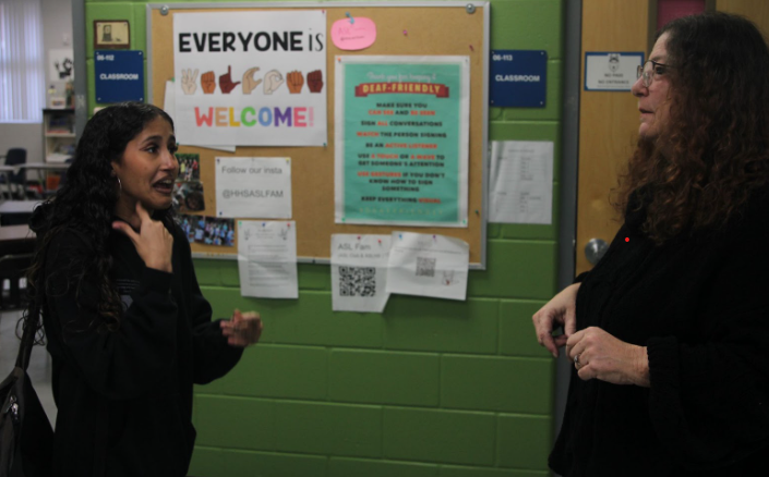 Junior Jiana Velez signing with ASL teacher Barbara Chaves. Velez is a member of Chaves's ASL 5 class.