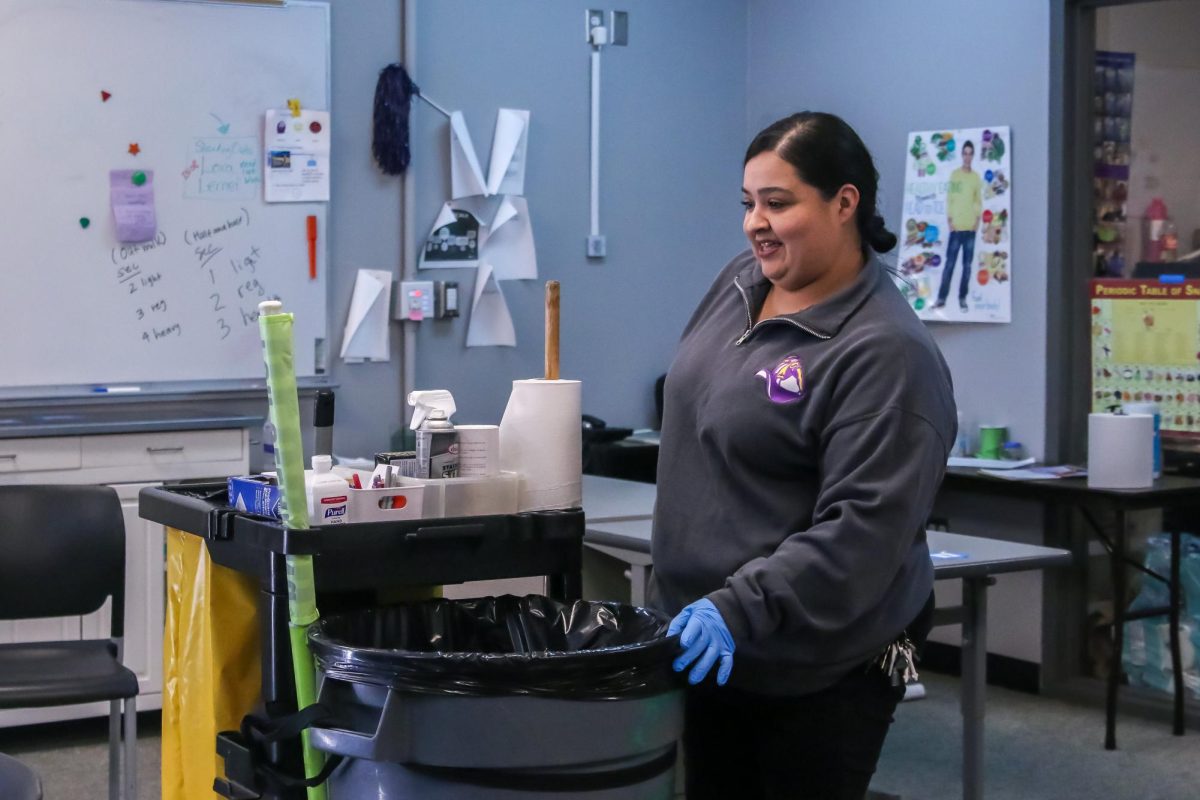 Cortez relocates her cleaning cart to another area. Photo | Liz Liu 