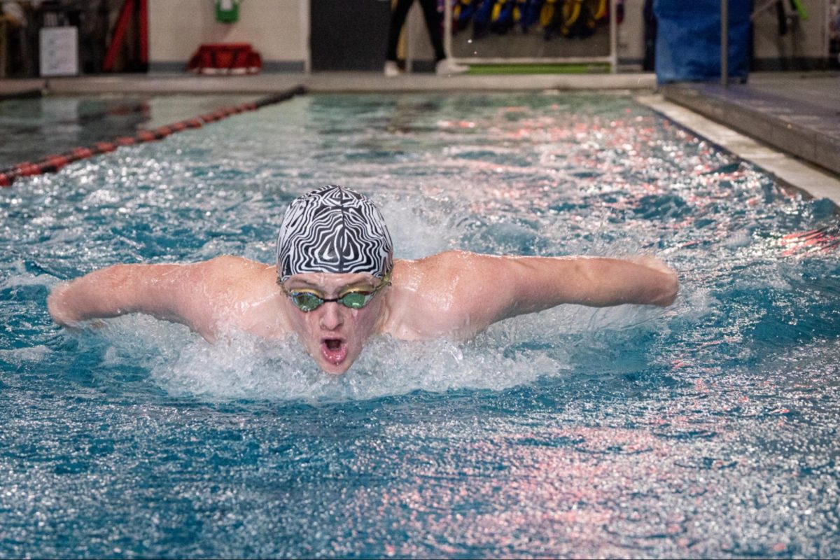 Coppell sophomore swimmer Jack Parshall practices the 100-yard butterfly in the YMCA swimming pool. As a sophomore, Parshall has become one of the premier names for swimming in Coppell, fighting through adversity. Photo by Wendy Le