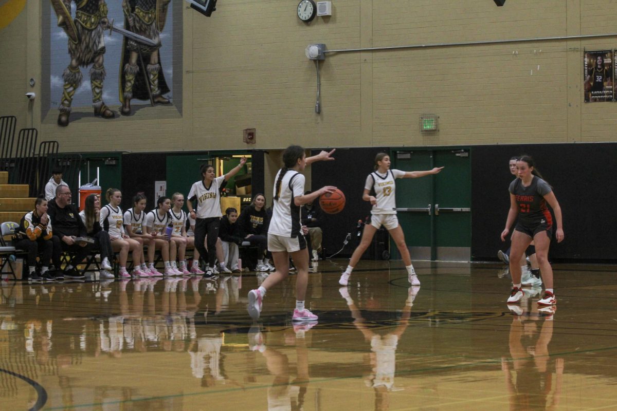 Malu Touras dribbles the ball up the court for the Vikings on Dec. 14 in the third quarter. The team beat Ferris High School 58-36 on Alumni Night while celebrating former athletes who have played for the team. 