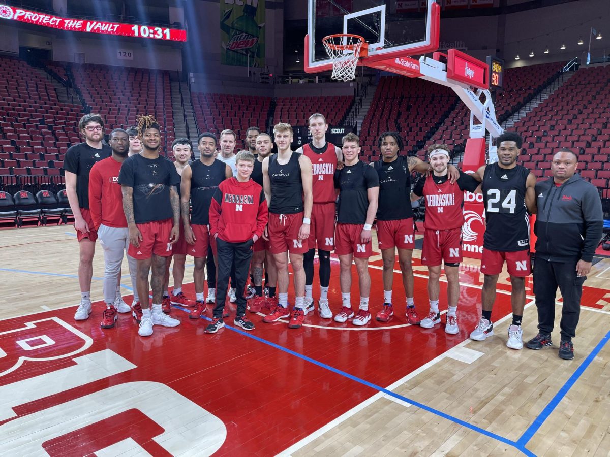 Before his open heart surgery in 2023, freshman Damon Dauel poses with the Nebraska Men's Basketball Team after being invited to come watch practice by Husker Head Coach Fred Hoiberg. Hoiberg had a special connection with Dauel as he himself had a heart condition which ended his NBA playing career in 2005. 