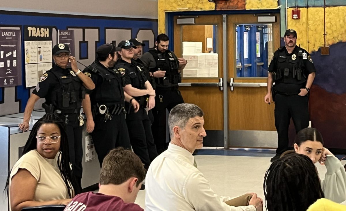 Several of the AISD police officers who remained on campus to aid with dismissal after it was deemed safe to lift the secure hold on the campus attended the faculty briefing that took place in the cafeteria immediately after school.