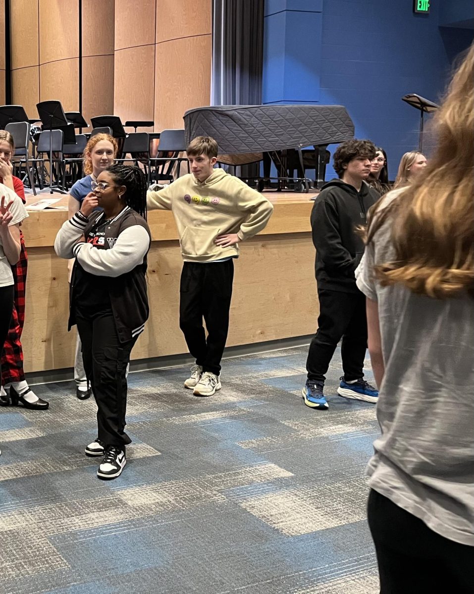 Palmer practices at a Revere Players rehearsal with the musical’s cast members. 